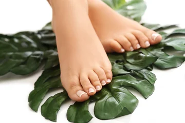 bare-feet-on-leaves-foot-care-and-pedicure-concept
