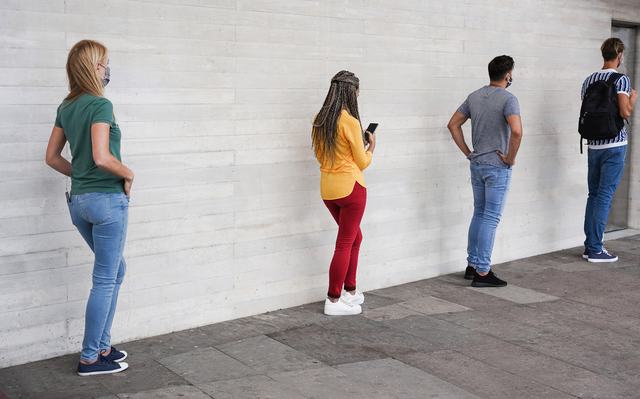 group-of-young-people-waiting-for-going-inside-shop-market-while-keeping-social-distance-in-line-during-coronavirus-time.jpg
