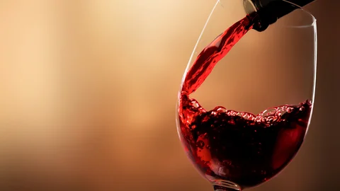 red-wine-pouring-from-bottle-glass