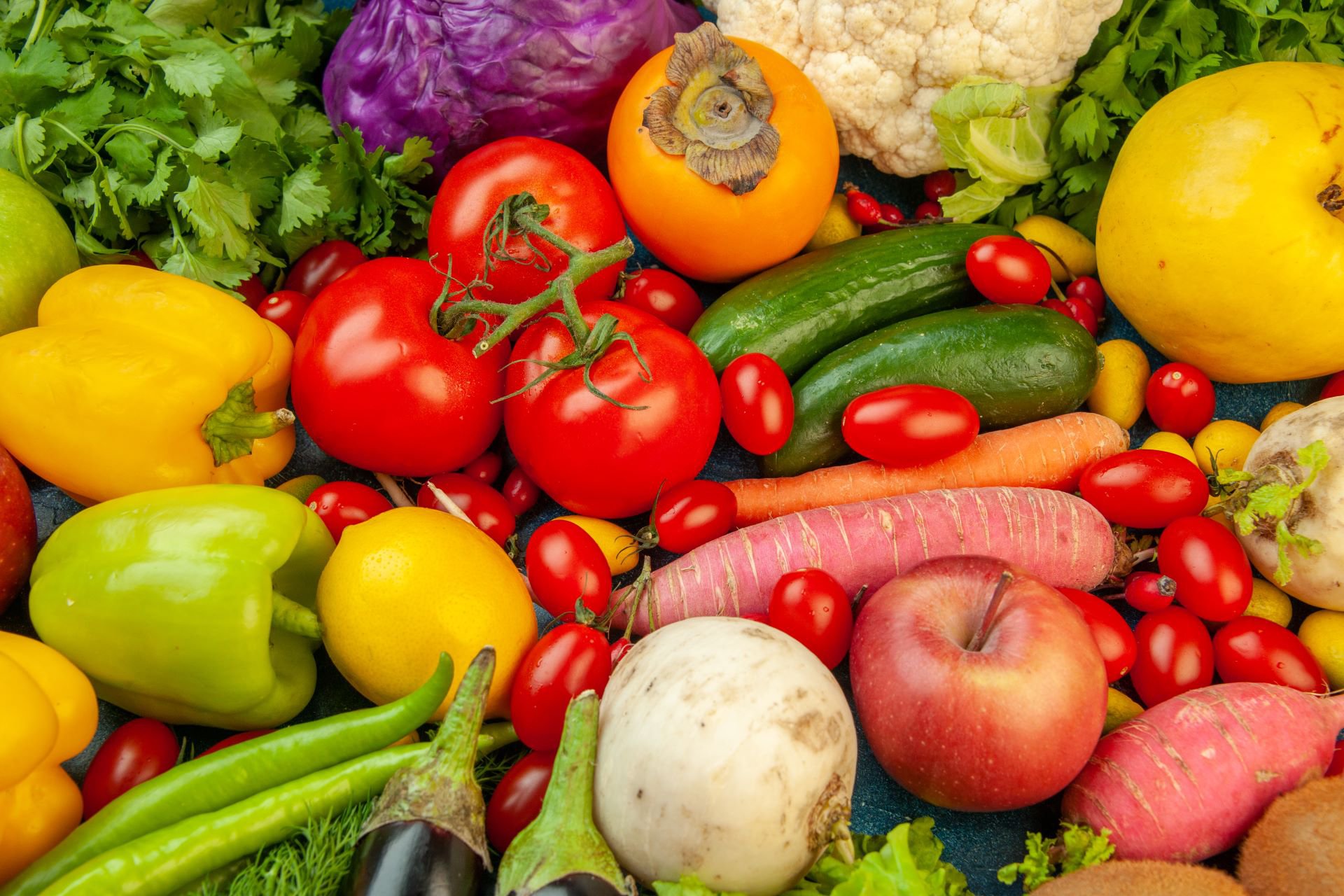top-view-fruits-and-vegetables-eggplant-bell-peppers-apples-carrot-coriander-cauliflower-persimmon-radish-cherry-tomatoes-on-blue-background
